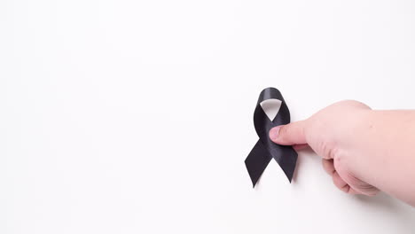 black awareness ribbon on gray background