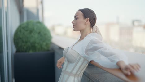 woman on balcony in corset