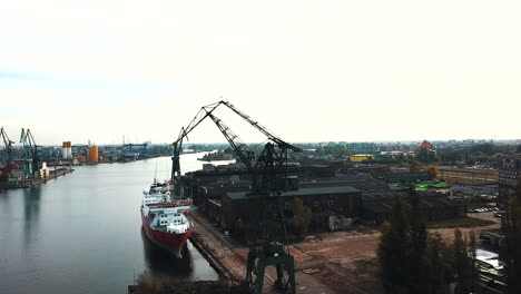 drone flying around cranes and cargo ships in the shipyard docks-1