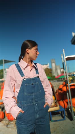 woman in pink and denim outfit at a pumpkin patch