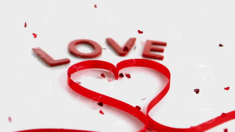 animation of word love and heart shape of red ribbon, with red hearts falling on white background