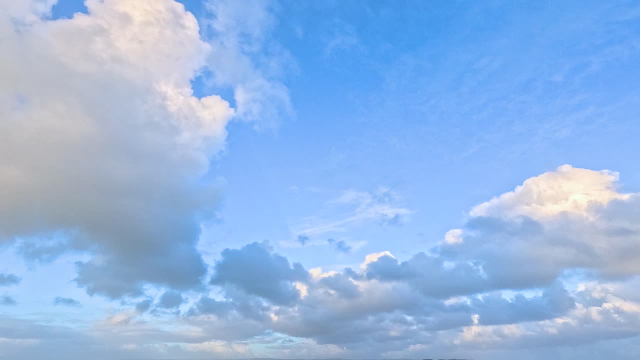 A serene landscape with sheep grazing in a lush field beneath a vast, cloud-filled sky. Captured along the Great Ocean Road