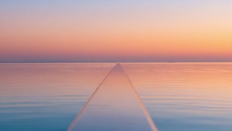 serene horizon: a tranquil perspective on a still waterway at sunset, capturing the rich tones of dusk reflected in the calm surface