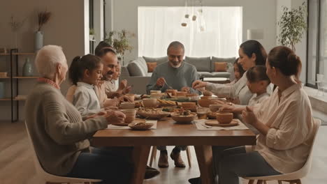 a multi-generational family enjoys a happy dinner gathering at home