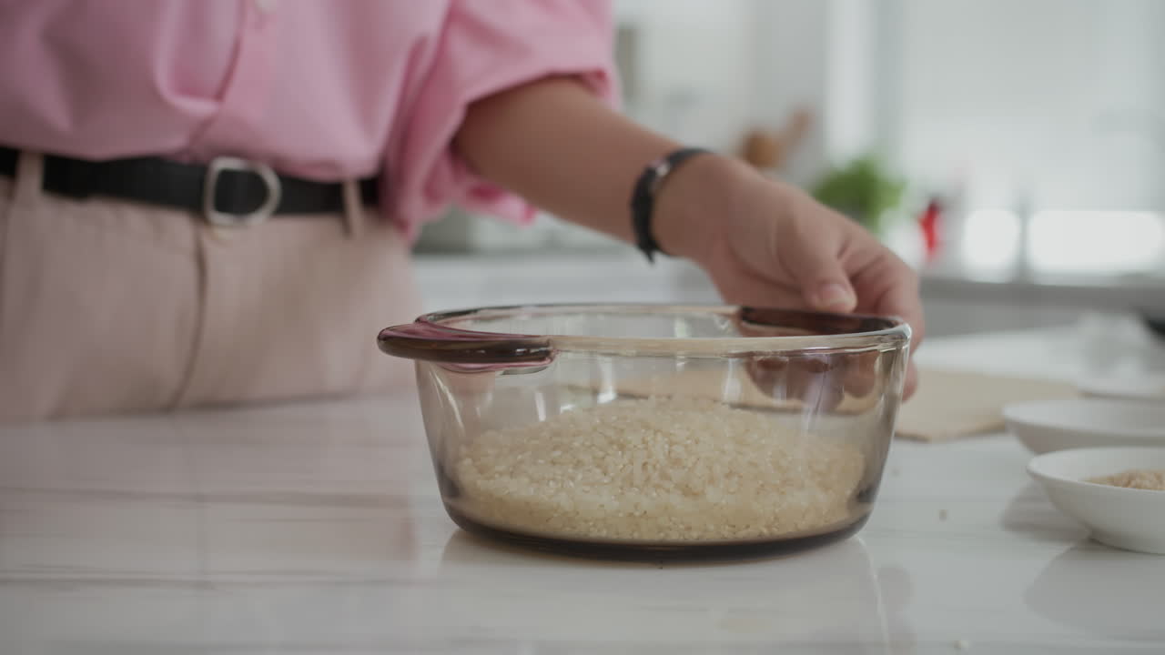 Hands of Unrecognizable Woman Adding Rice to Bowl