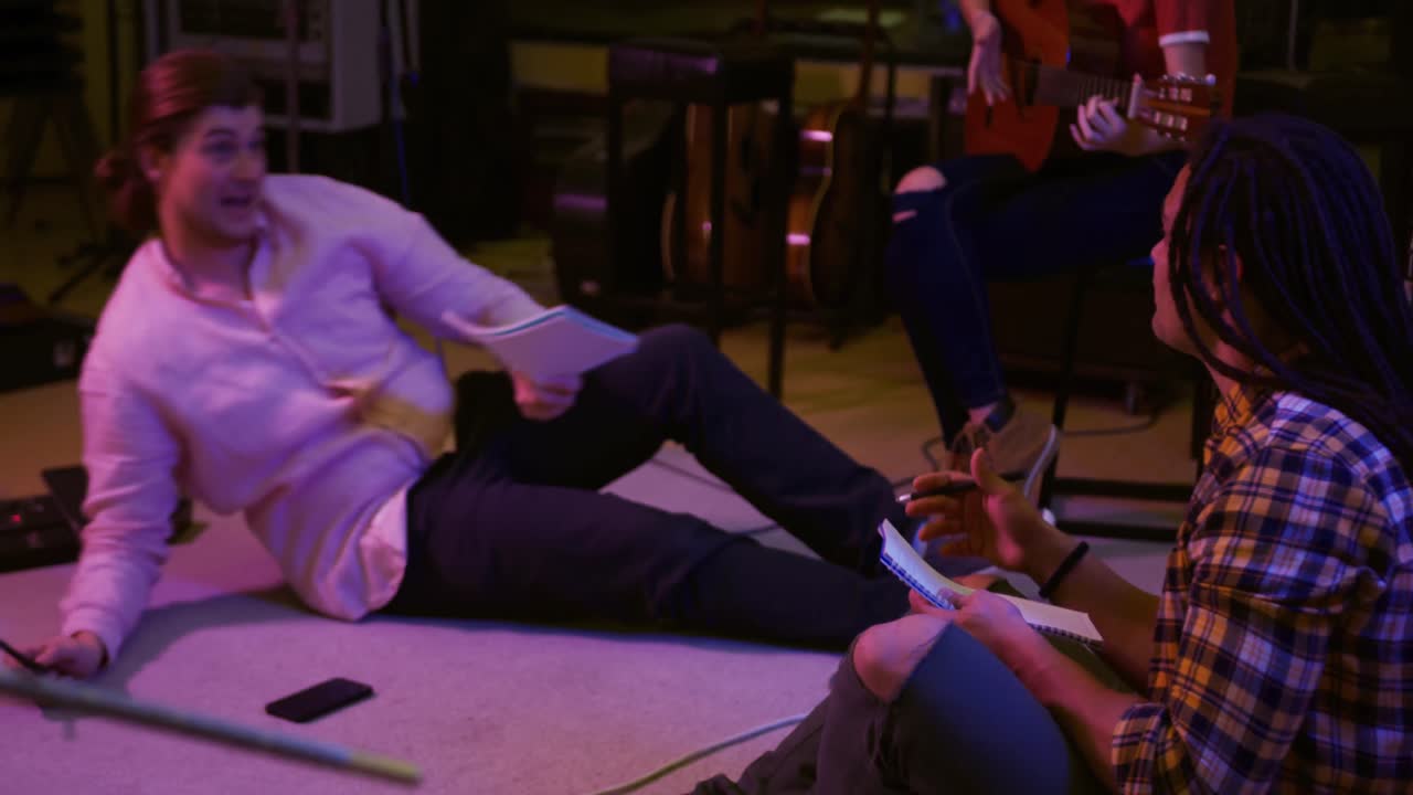 Music group discussing in a music studio