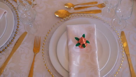 elegant gold place setting on a wedding table reception