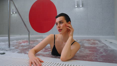 woman relaxing in a modern spa hot tub