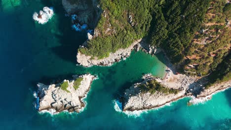 a rocky coastline with turquoise waters and lush greenery on a sunny day, aerial view