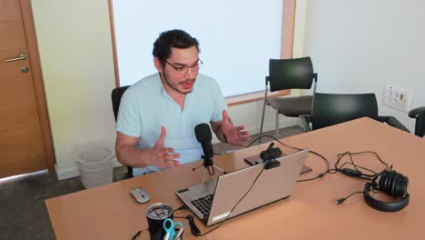 man giving a presentation or podcast from a home office