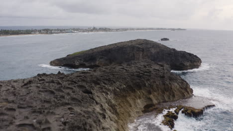 waves crash into rocky cliffs in cueva del indio in las piedras near arecibo, puerto rico