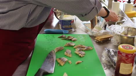 Time-lapse-of-kitchen-staff-preparing-fish-and-another-dish-in-the-backgroud