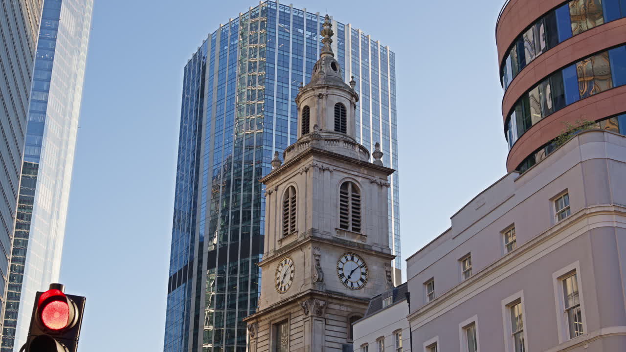St. Botolph-without-Bishopsgate church standing prominently at the edge of Liverpool Street, framed by gleaming glass towers in London, England
