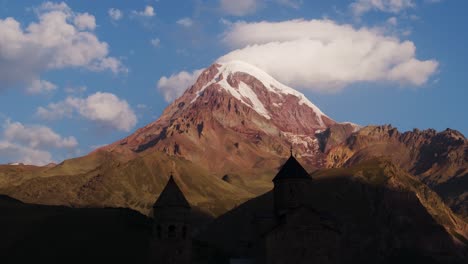 beautiful drone shot above gergeti trinity church, mount kazbek