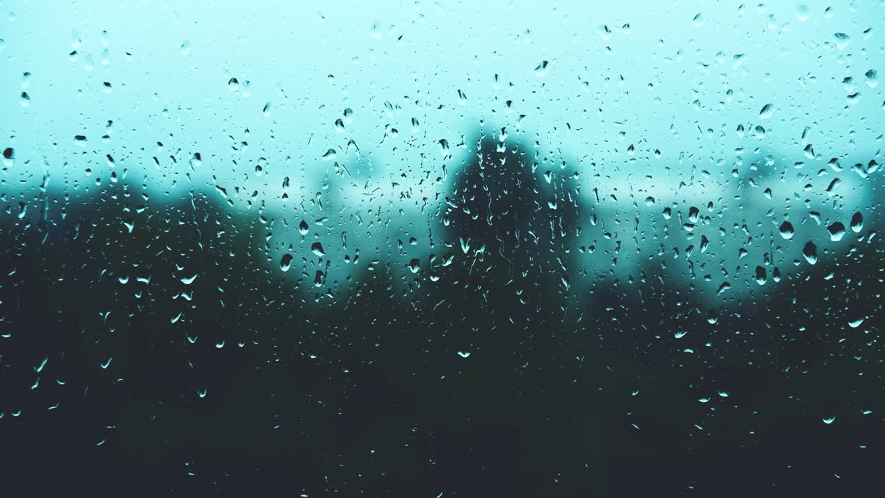 Rain drops strike window pane