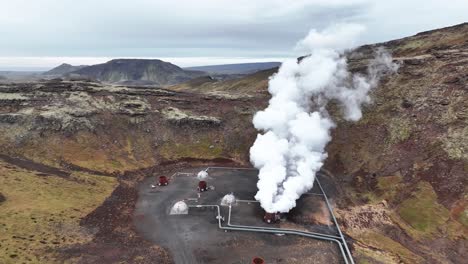 steam coming out of exhaust pipe at geothermal power plant in south iceland