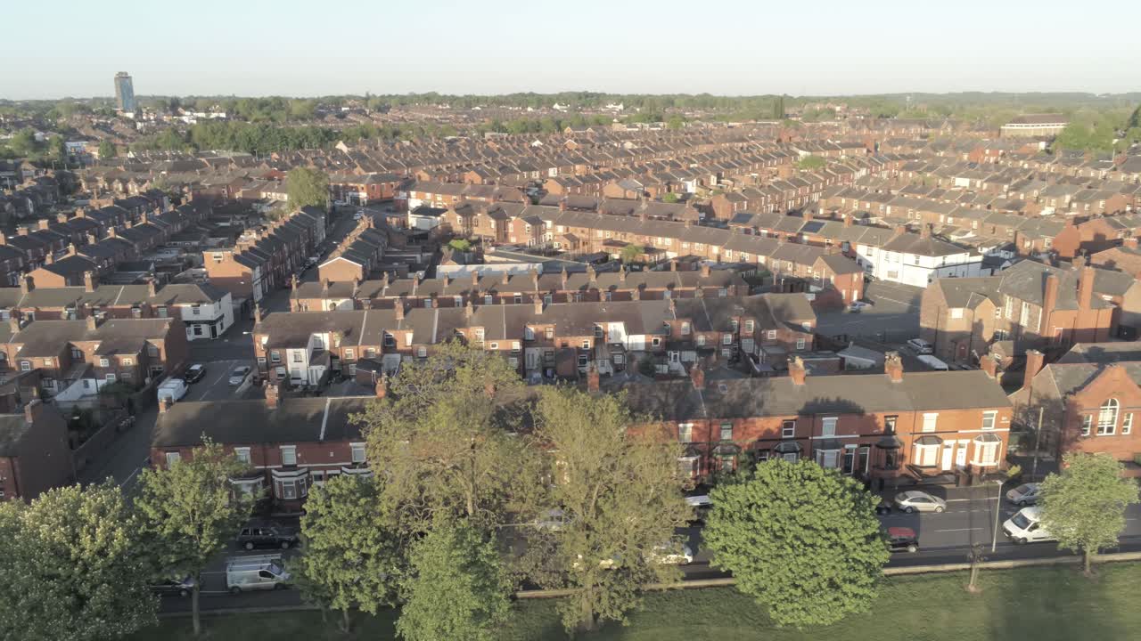Drone aerial view across British typical residential housing estate dolly left