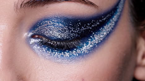 close-up of artistic blue and silver eye makeup