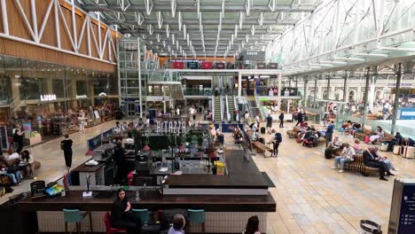 people bustling in paddington station, london