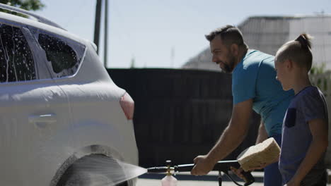 father and son washing a car
