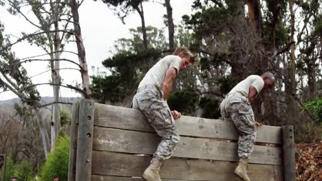 military soldiers climbing a wooden wall at boot camp 4k