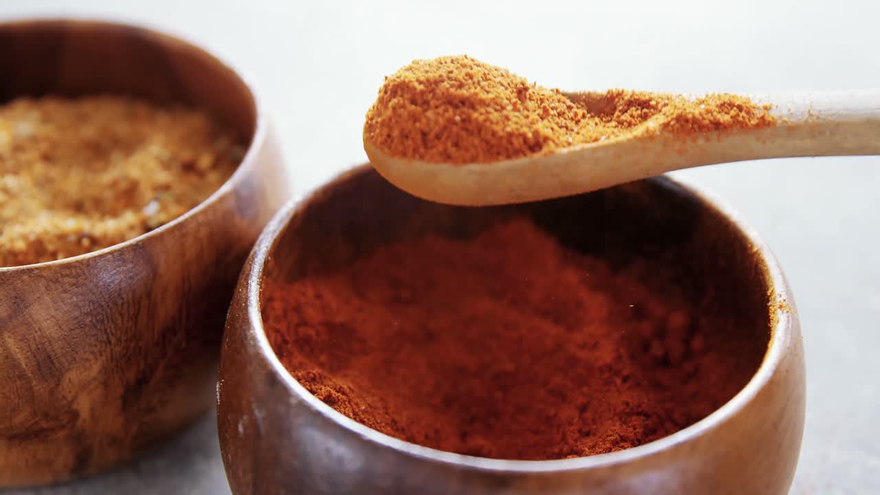Cinnamon powder and red chili powder in bowl 4k