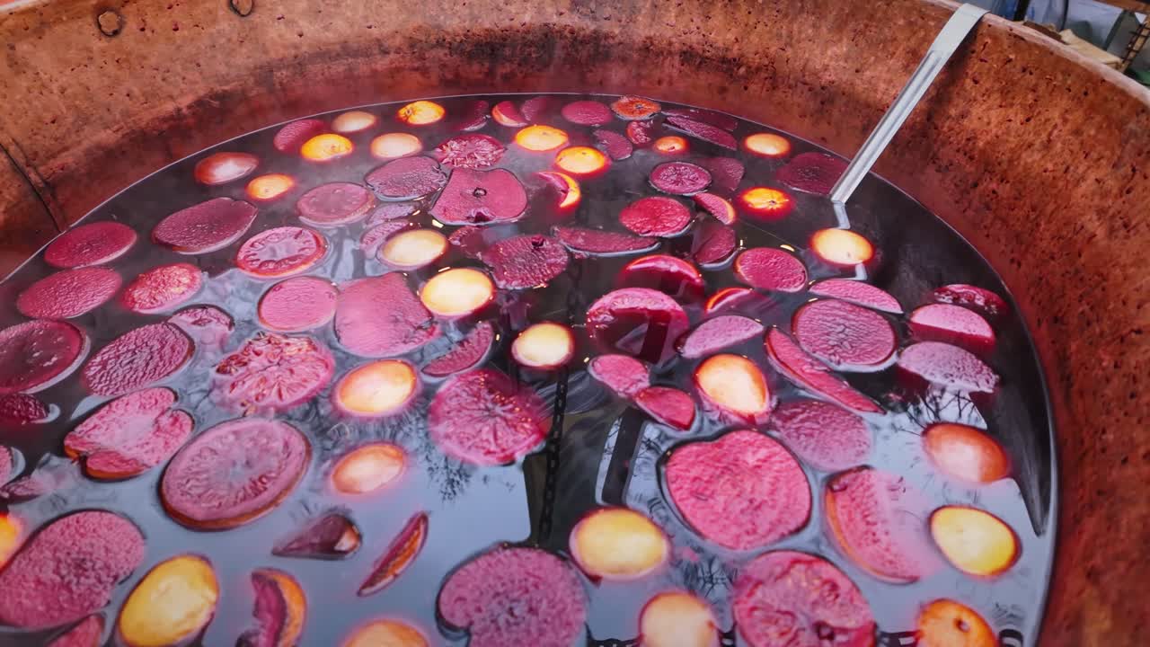 Cauldron of Aromatic spiced alcohol mulled fruity wine CLOSE-UP