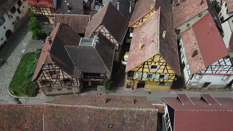 a dolly aerial footage moving to the left alongside a street of the village