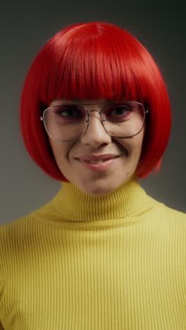 woman with red wig and yellow sweater