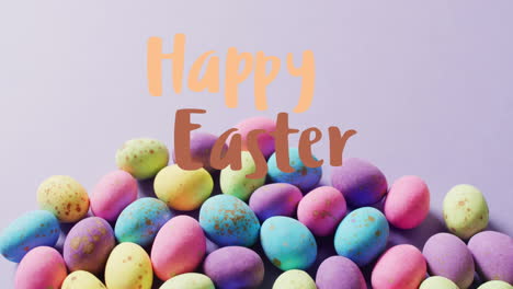 animation of happy easter text over colourful easter eggs on purple background
