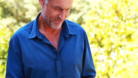 smiling mature man using digital tablet in balcony