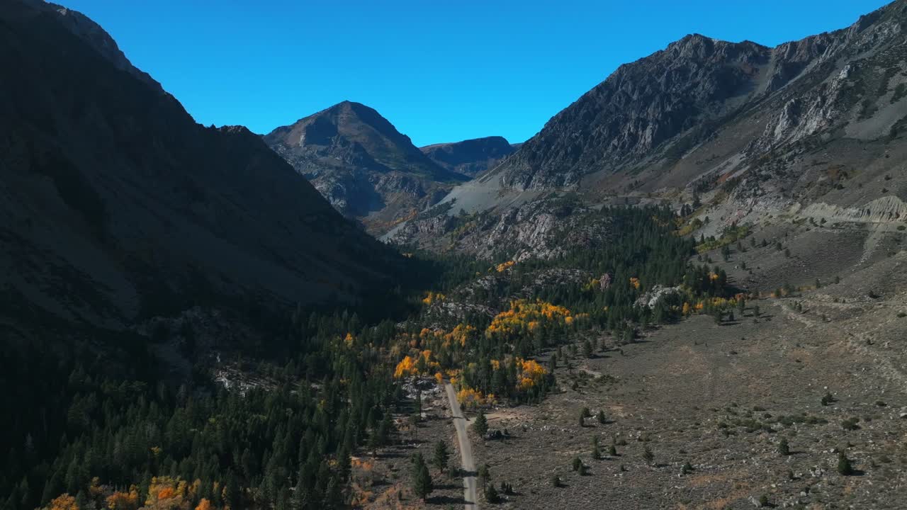 West Portal Entrance rugged Mountains Lee Vining Tioga Pass Road Yosemite National Park California aerial drone Ansel Adams Wilderness Big Oak Flat fall yellow orange Aspen Trees blue skies forward up