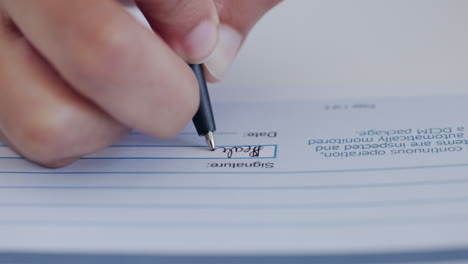 person signing a document