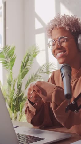 young inspired african american woman blogger hosts video podcast via laptop