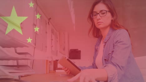 animation of data processing and flag of china over caucasian businesswoman using tablet