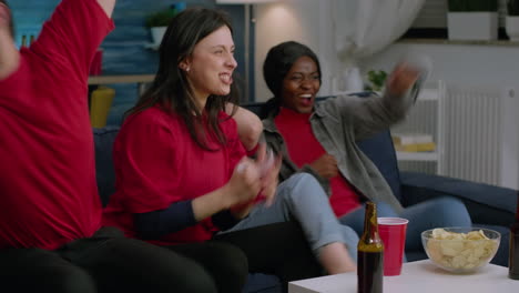 exicited multi-ethnic friends group cheering together after foottball team winning match competition