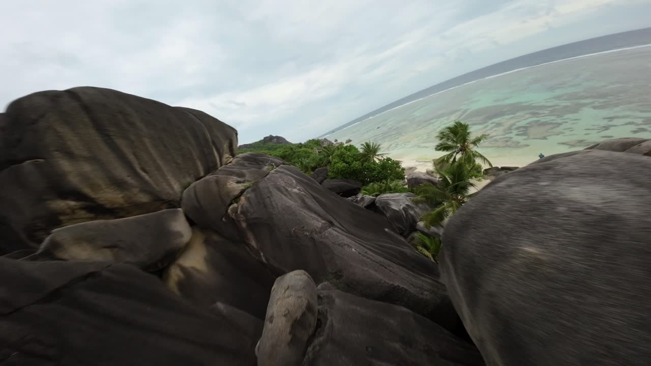 Fpv drone flying on a Anse Source d'Argent beach in Seychelles on an Island Mahe, video of incredible trees, Seychelles rocks, seaside, and surrounding Seychelles landscapes