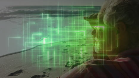 Senior man holding spyglass on sandy beach, showcasing green digital grid overlays for technology