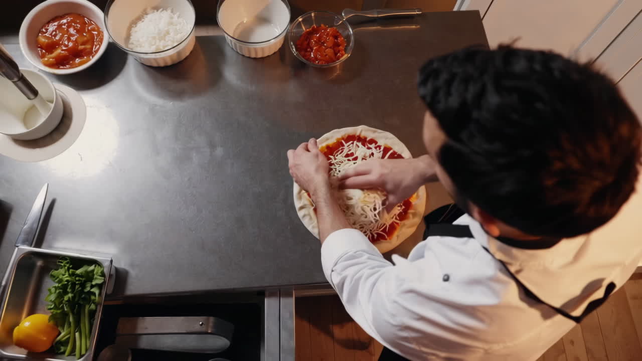 Chef Preparing Pizza with Cheese and Sauce