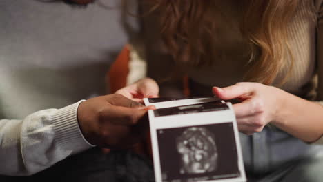 white woman and black boyfriend with ultrasound pictures