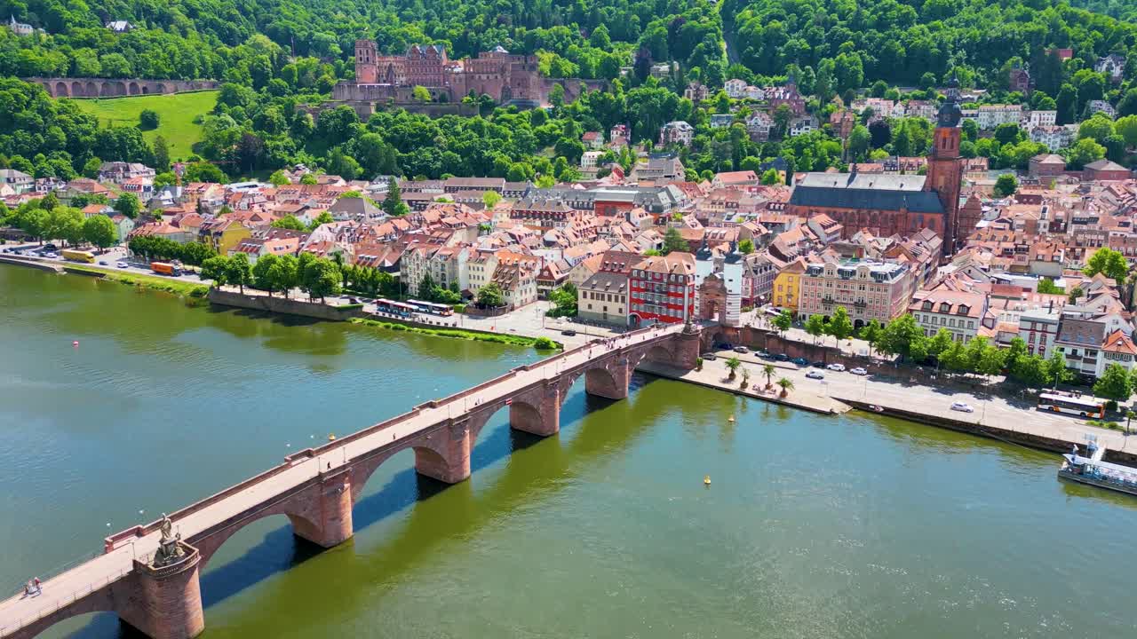 4K Aerial Drone Video of Historic Heiliggeistkirche Church, Castle on Königstuhl Hill, and Old Bridge on the Neckar River in Heidelberg, Germany