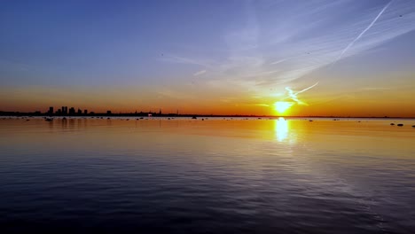 tallin in sunset, setting over the water, creating a beautiful and serene atmosphere