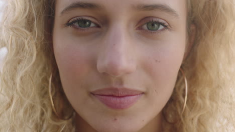 close-up-portrait-of-beautiful-young-blonde-woman-face-looking-at-camera-pensive-thinking-wearing-earings