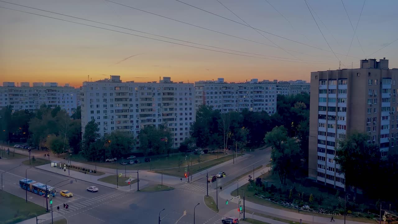 Cityscape at Sunset with Apartment Buildings and Traffic