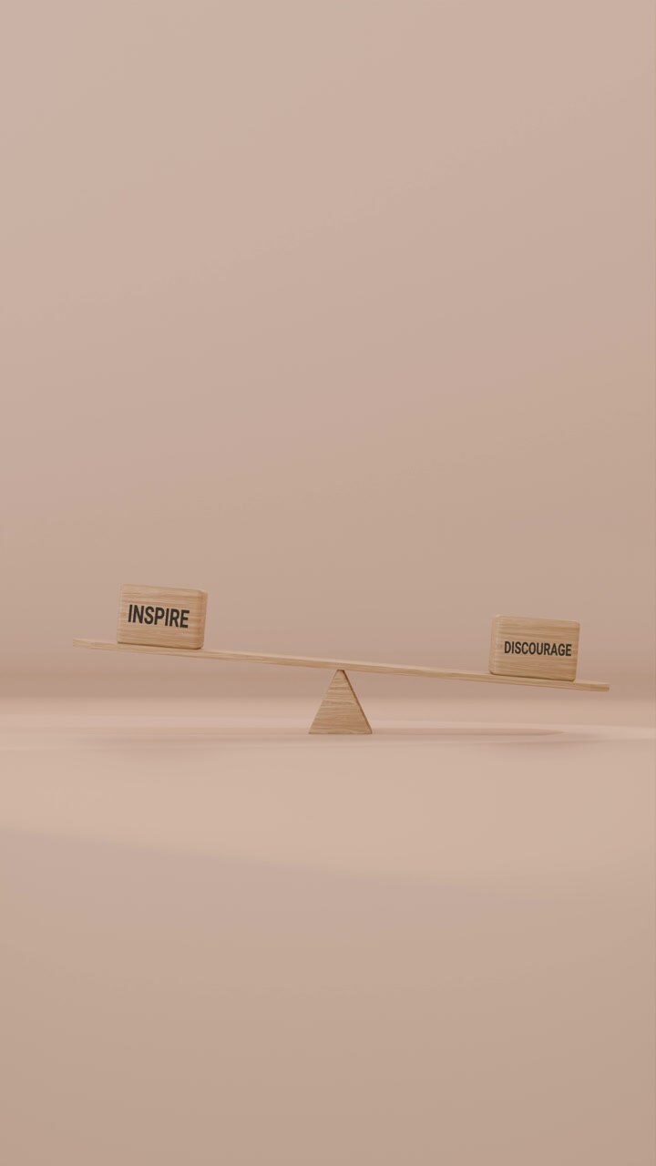 VERITCAL VIDEO OF INSPIRE AND DISCOURAGE BALANCING ON SEESAW