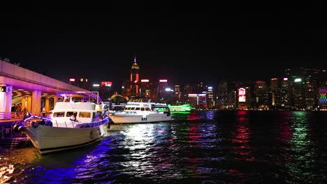 boats and city lights reflecting on water