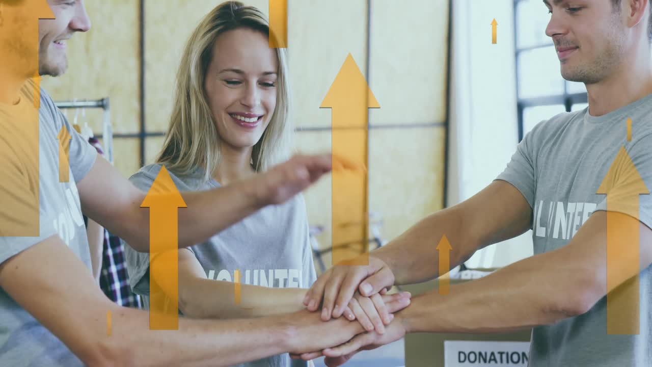 Animation of yellow arrows over happy caucasian volunteer group stacking hands