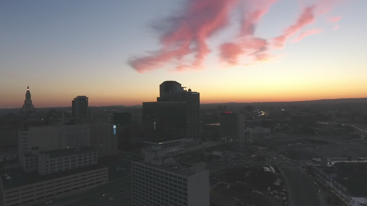 Aerial sunset pan out of city