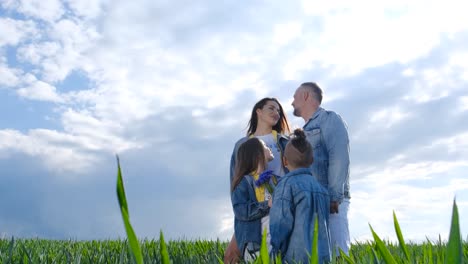 happy family are walking in the open green field happy family are walking in the open green field friendly family vacation together hiking in nature from a birds eye view people spend time carefree outdoors in the summer in a public park