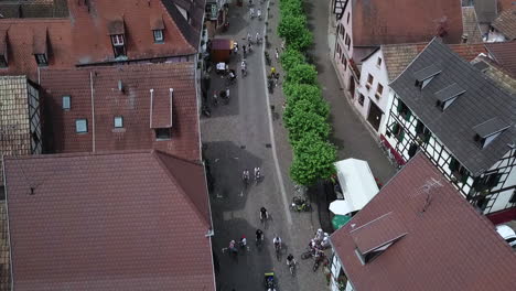 an top-view aerial footage moving onwards following the path of the main street of the village